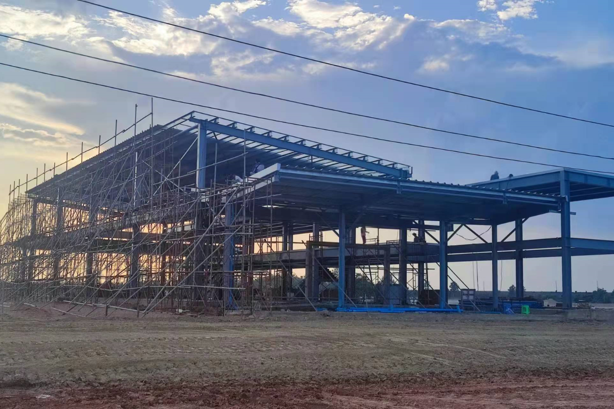 Advanced steel structure work at the Emerald E-Commerce Center in Naypyidaw, Myanmar, with extensive scaffolding for super structure completion.