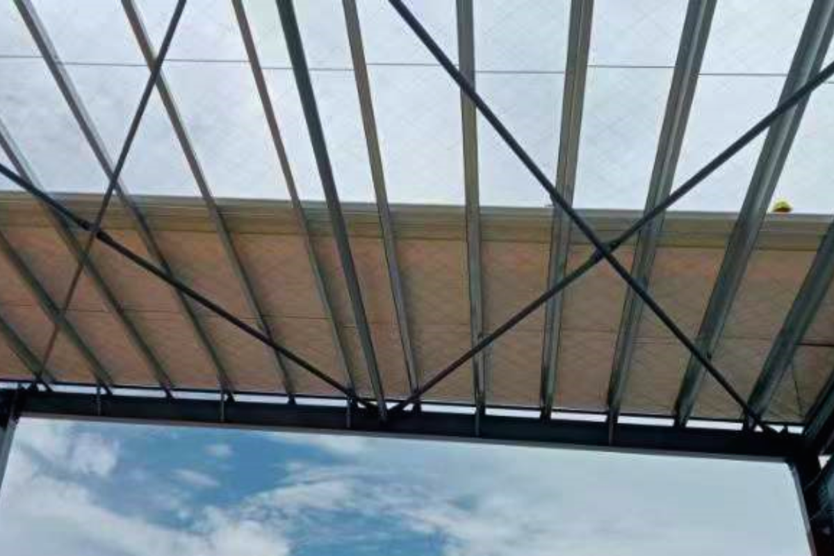 Close-up view of the steel roof structure and ceiling panels being installed at Emerald E-Commerce Center in Naypyidaw, Myanmar, part of the super structure work.