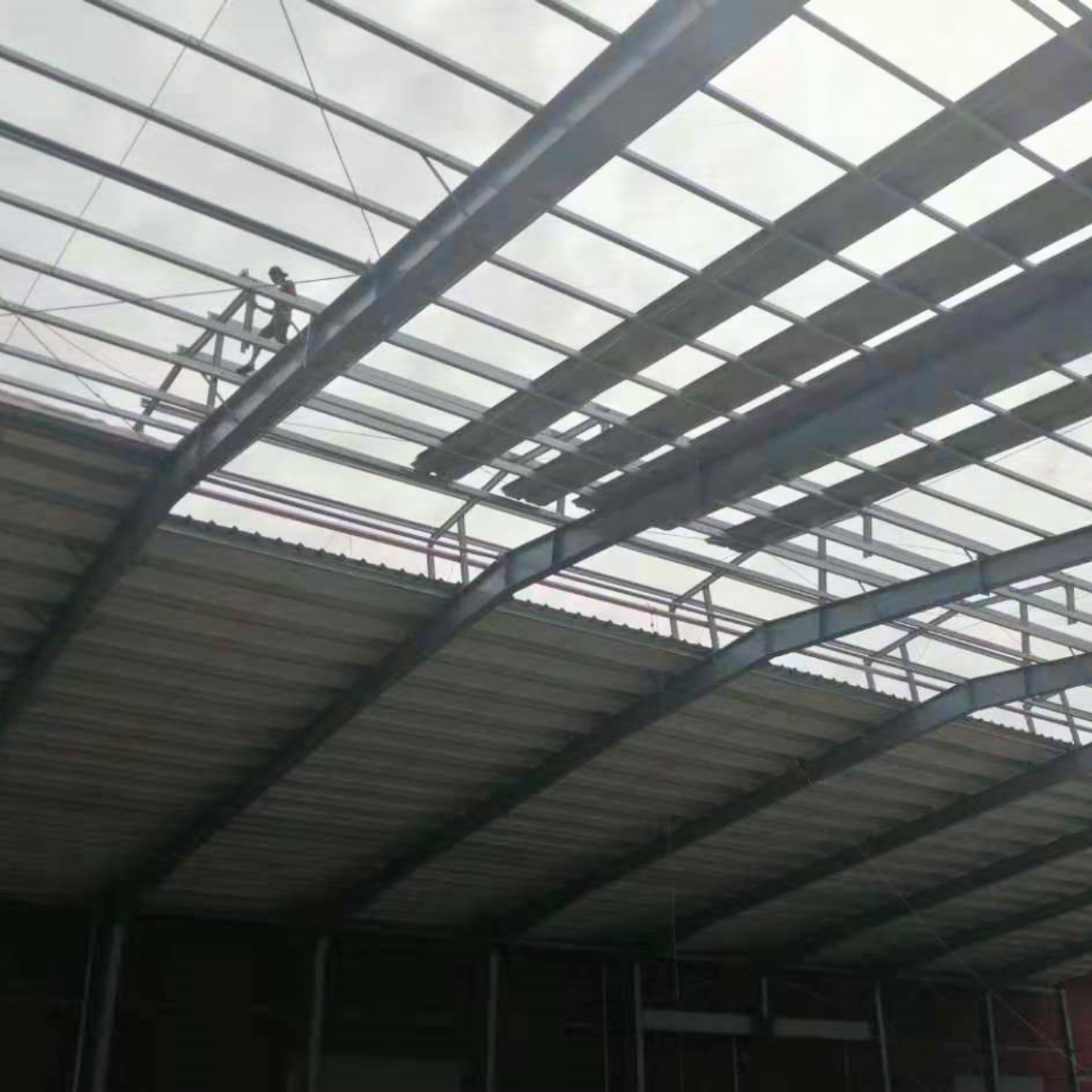Interior view of a completed steel structure roof by Myanmar Yi Jin, showcasing the robust framework and installed sheeting at their project site