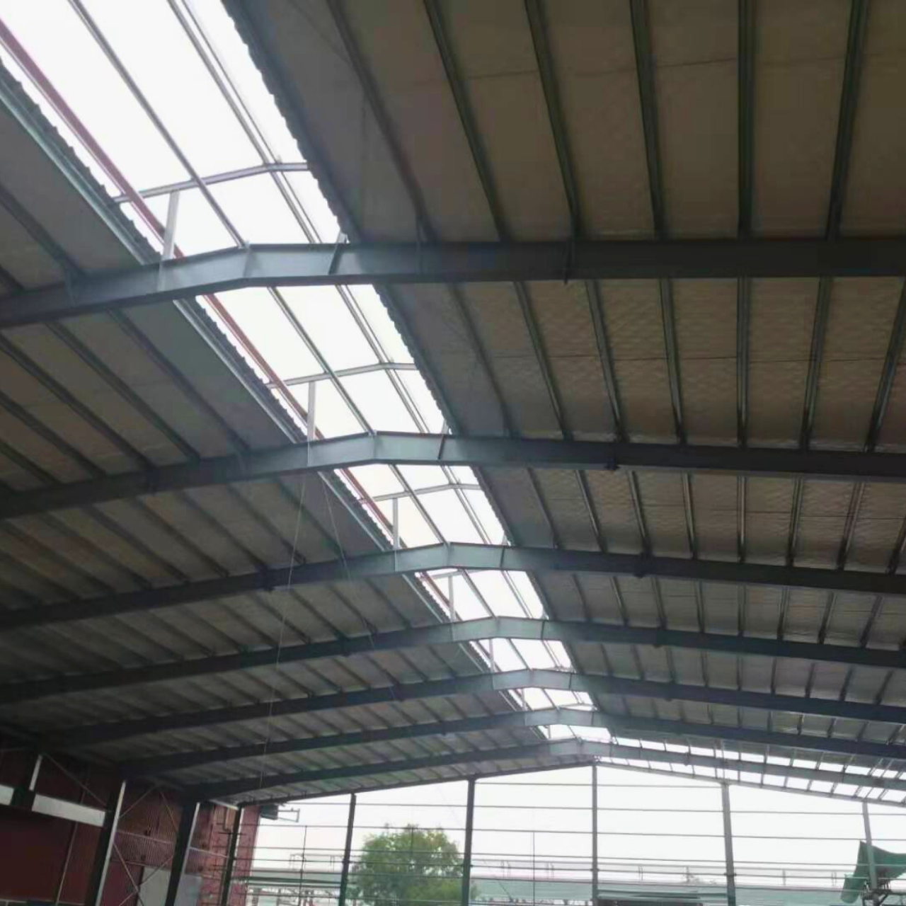 Natural light panels and a completed roof structure at a Myanmar Yi Jin steel warehouse project site