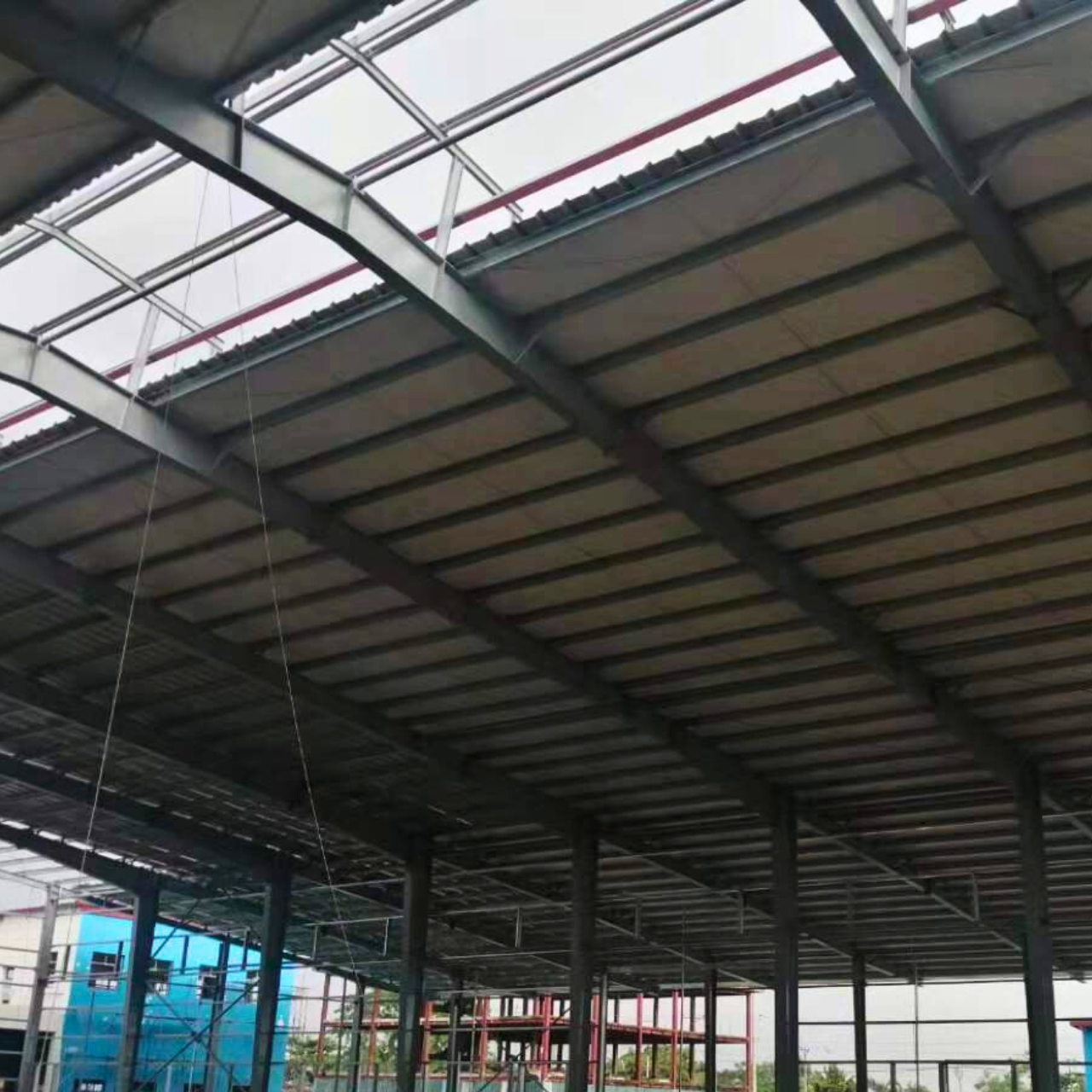 Roof panel installation in progress by Myanmar Yi Jin at a steel structure warehouse project site, detailing their construction methods."