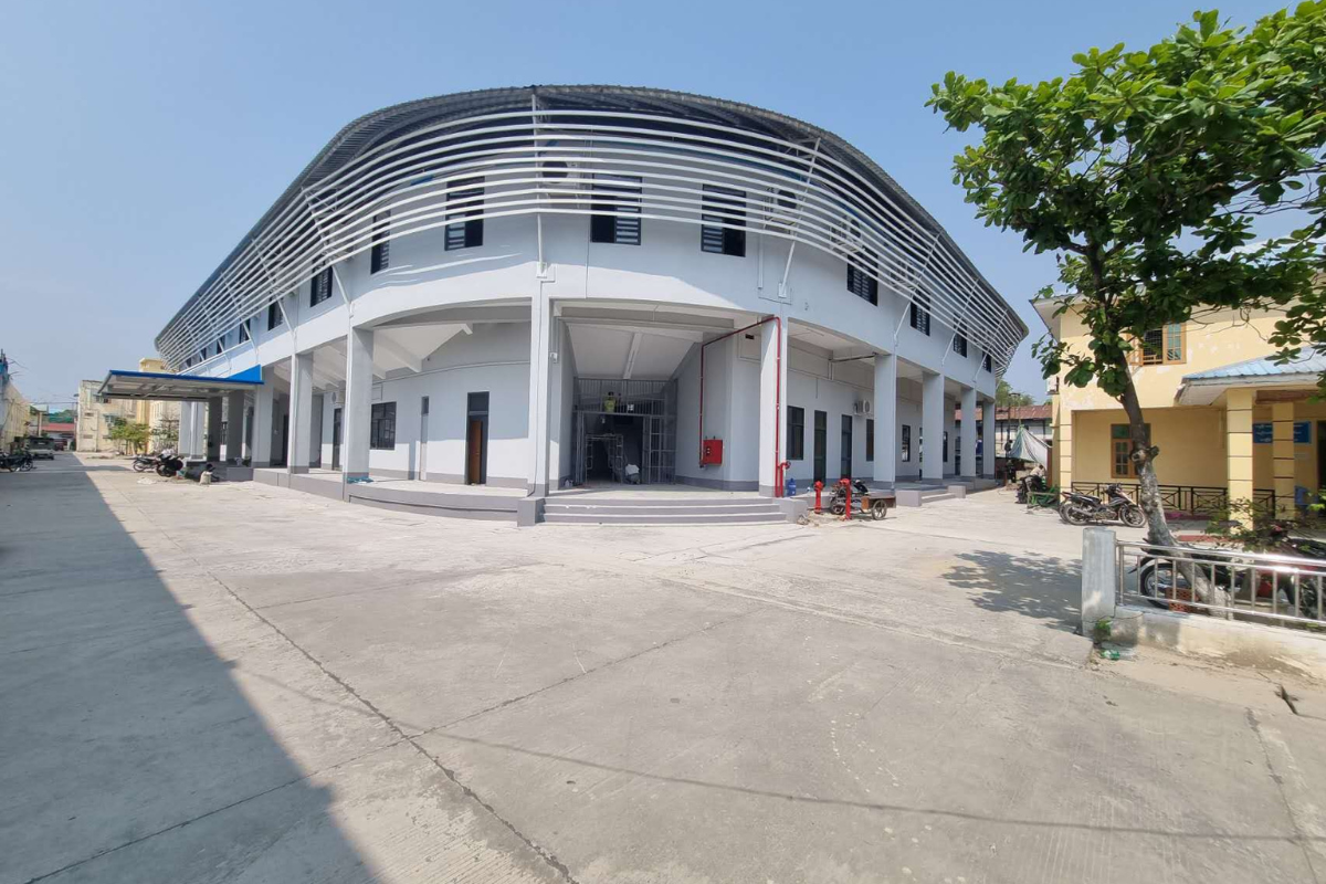 Exterior view of the completed Ba Htoo Indoor Sport Stadium building in Mandalay, Myanmar, showcasing its modern facade and surrounding area.
