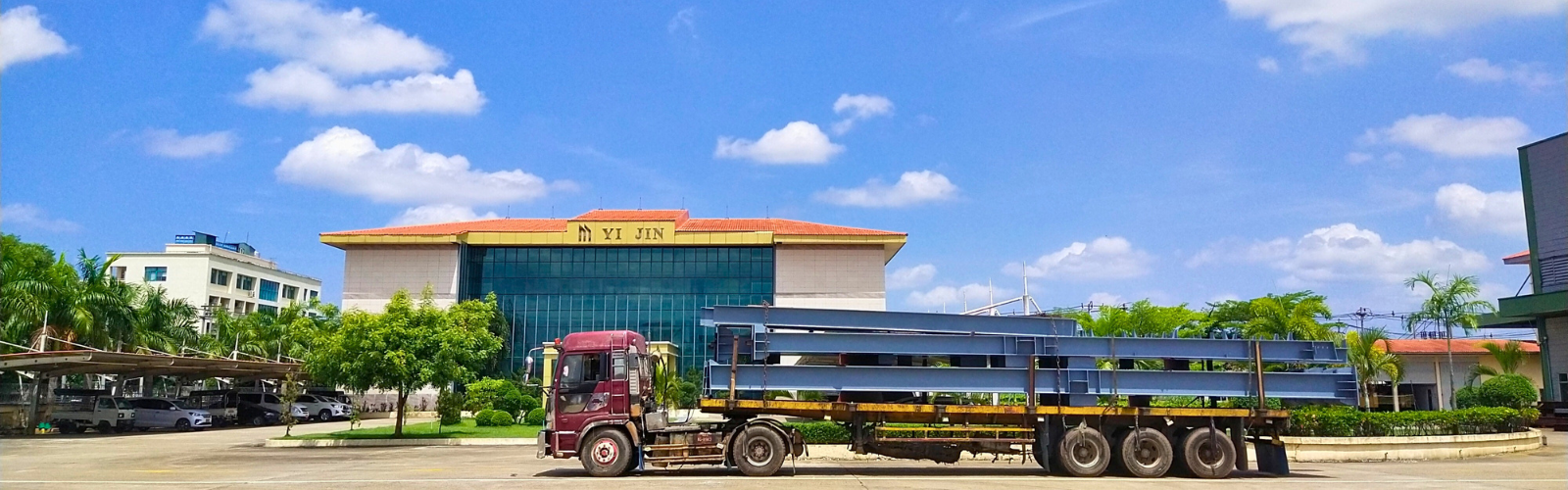 Heavy H steel beams fabricated by Myanmar Yi Jin are being loaded onto a truck at their factory in Yangon, Myanmar, for transport to a steel structure project site.