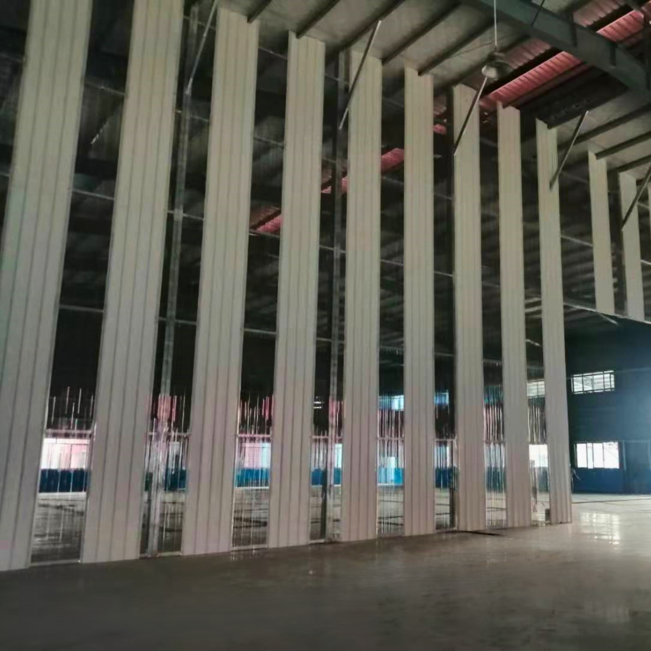 Interior view of finished vertical wall panels or partitions within a steel structure warehouse completed in Yangon, Myanmar, showcasing the customizable internal layout.