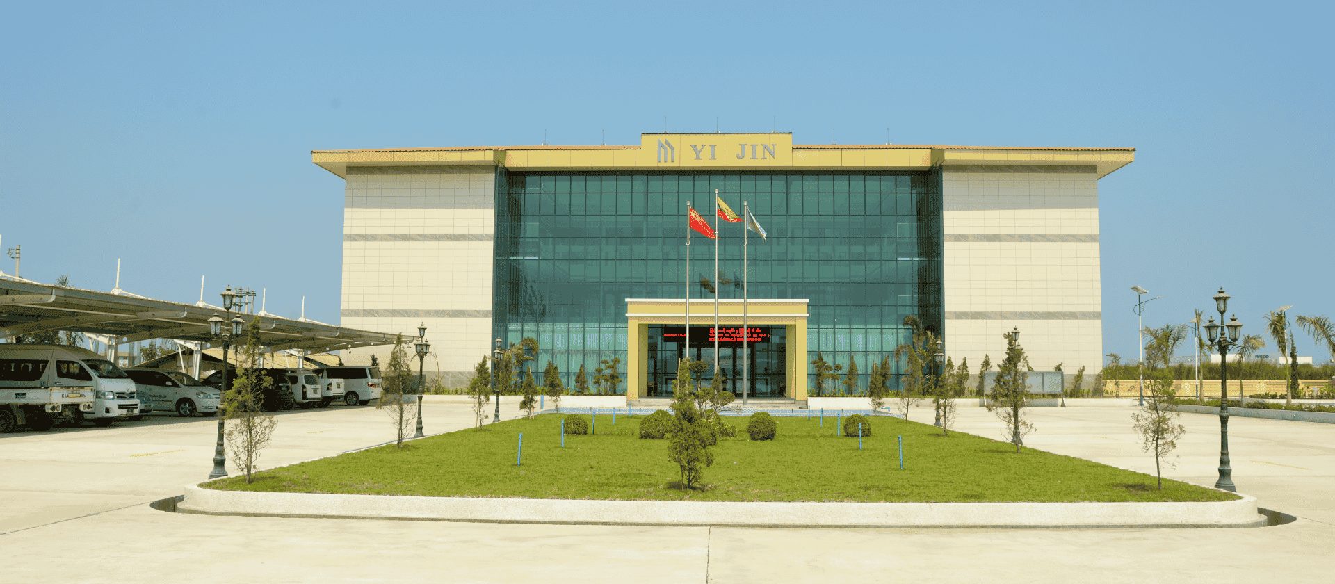 Front exterior of the Myanmar Yijin building with a red company flag