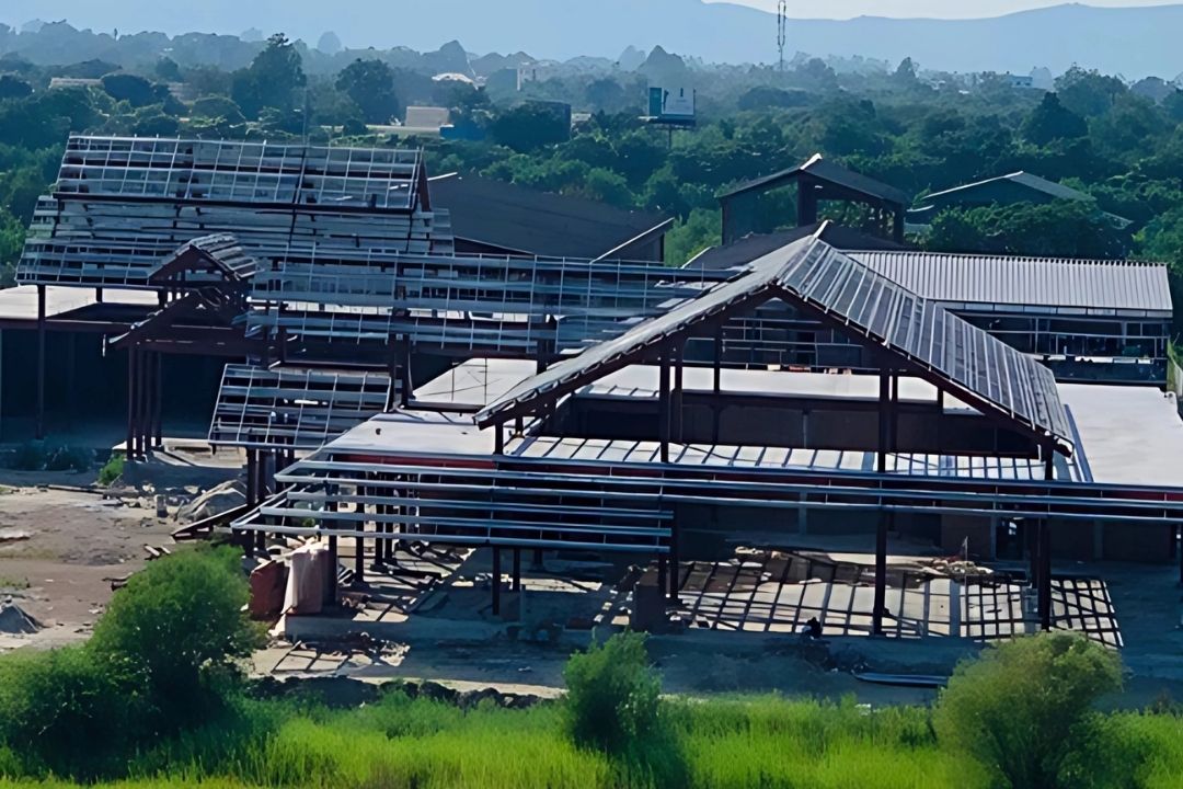 A high-angle view of the Mandalay Jade Market project by Myanmar Yi Jin, showing the ongoing Phase I construction of the 11,661m² complex, with the steel frames of multiple buildings visible.