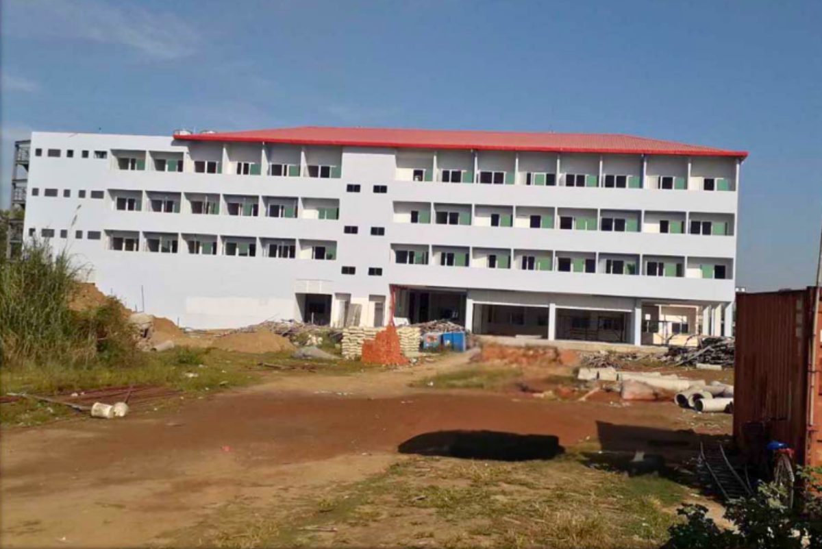 Exterior view of the completed 4-storey RCC building for Myanmar Panda Manufacturing Company Limited, featuring a white facade and red roof, constructed by Myanmar Yi Jin.