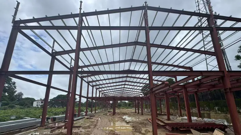 Ongoing steel structure construction for 11.6m high car showroom and workshop facility in Yangon