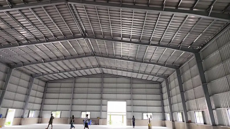 Interior view of steel frame roof structure and high ceiling for Oriental Light Co. Ltd warehouse in Yangon