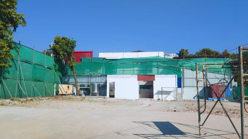 Groundwork and boundary safety netting setup at the Aung Kan Bo 4-storey steel structure building construction site in Mandalay.
