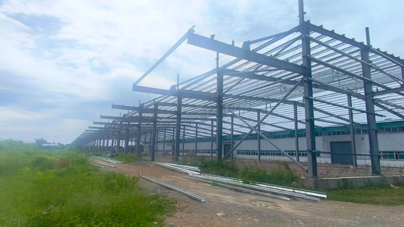 Exterior steel framework and roof purlin installation for Aung Kan Bo Truck and Machinery factory extension project in Mandalay.